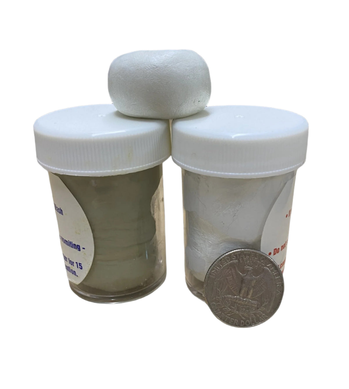 Two containers of Magic-Sculpt white epoxy clay with a small sculpting ball placed on top, alongside a quarter for scale.